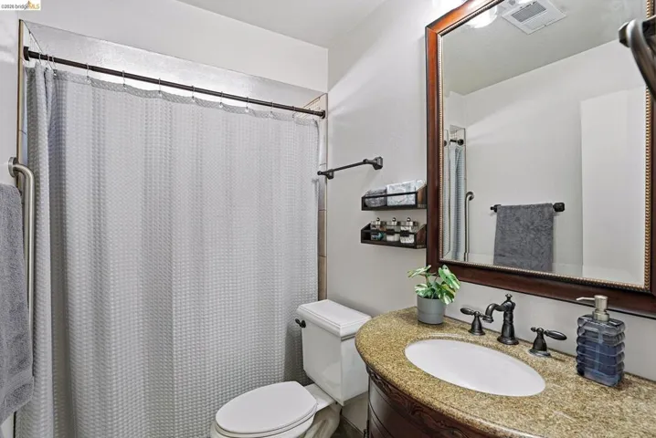 Full bathroom with vanity and curtained shower