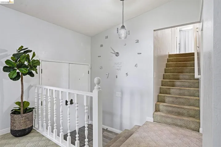 Stairway featuring baseboards and wood finished floors
