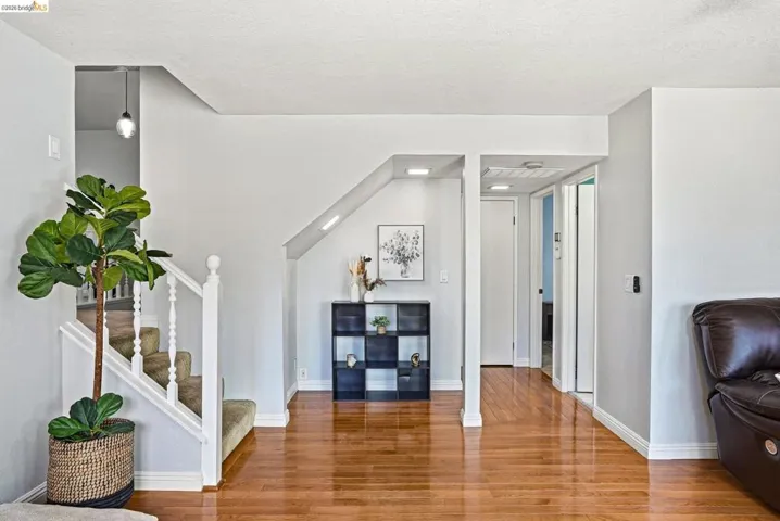 Living area with wood finished floors and recessed lighting