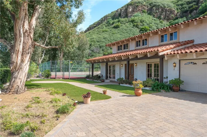 large front yard with access to your private full size tennis court