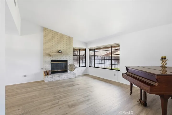 Light-filled living room with focal-point fireplace adjoins formal dining