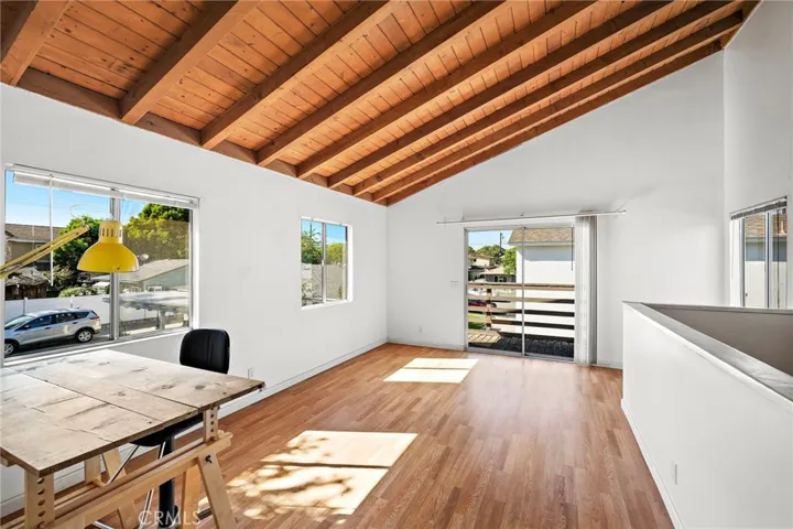 Primary Bedroom Upstairs with wood beamed ceilings