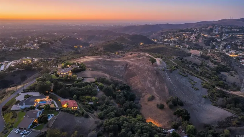 Stunning twilight capture highlighting the property's exceptional elevation and 180-degree views