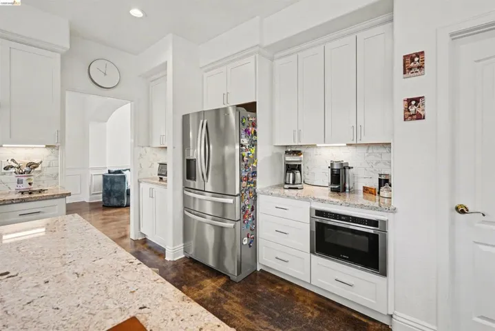 Kitchen featuring stainless steel appliances, white cabinetry, and recessed lighting