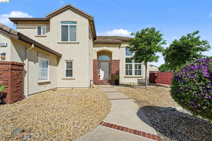 Mediterranean / spanish home with stucco siding and a tile roof