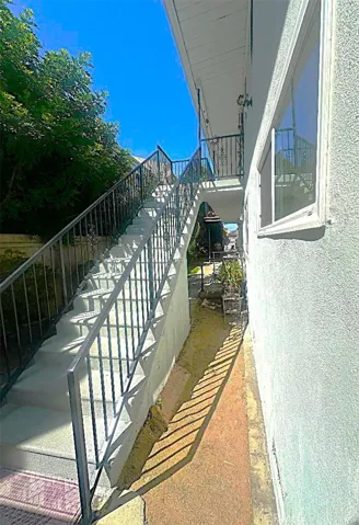 There is a Second Rear Stairway Adjacent to the Garages Leading to the Upper Level.