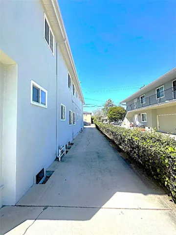 The long Driveway Leads From the Front of the Propeerty to the Rear Garages.