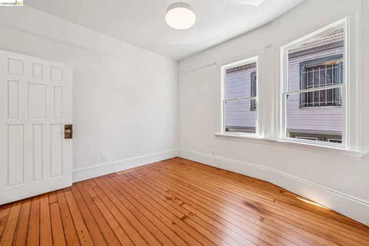 Empty room with light wood-type flooring and baseboards