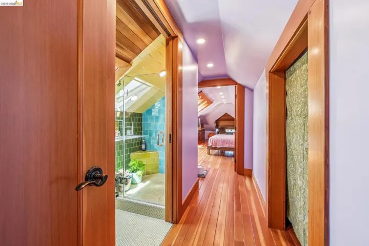 Corridor with vaulted ceiling, recessed lighting, and light wood-style floors