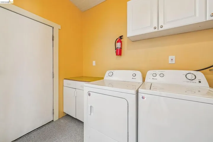 Laundry room featuring cabinet space and separate washer and dryer