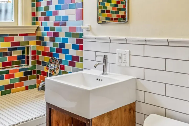 Bathroom with vanity and tile walls