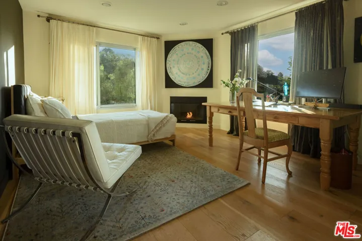 Bedroom with fireplace and vie