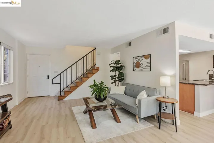 bedroom featuring wood finished floors and ensuite bathroom