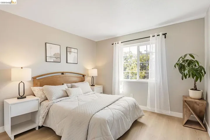 bedroom with light wood-style floors and baseboards