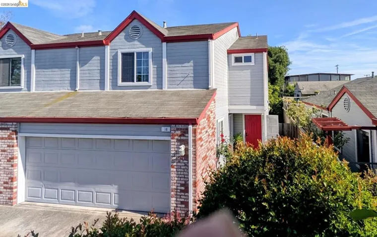 view of front of home featuring brick siding, a garage, concrete driveway, and roof with shingles