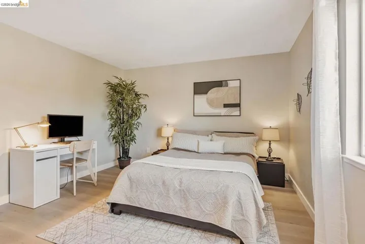 bedroom featuring light wood-type flooring and a desk