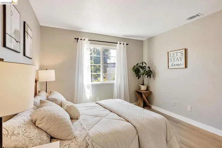 bedroom with baseboards and wood finished floors