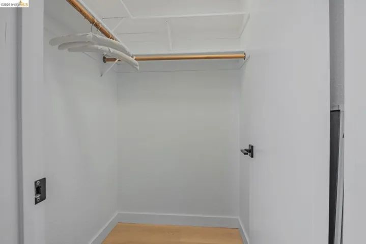walk in closet featuring light wood finished floors