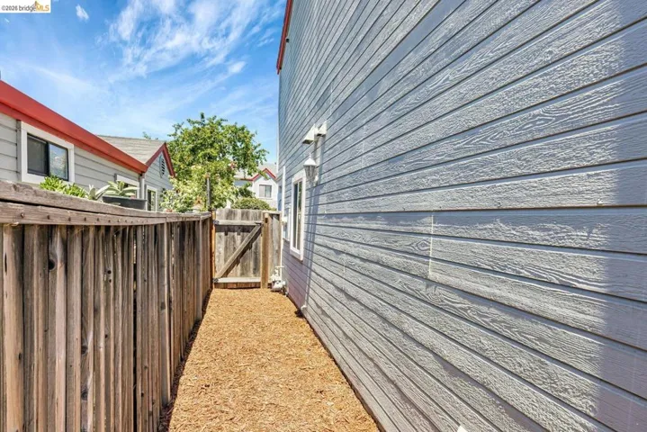 view of side of home with a gate