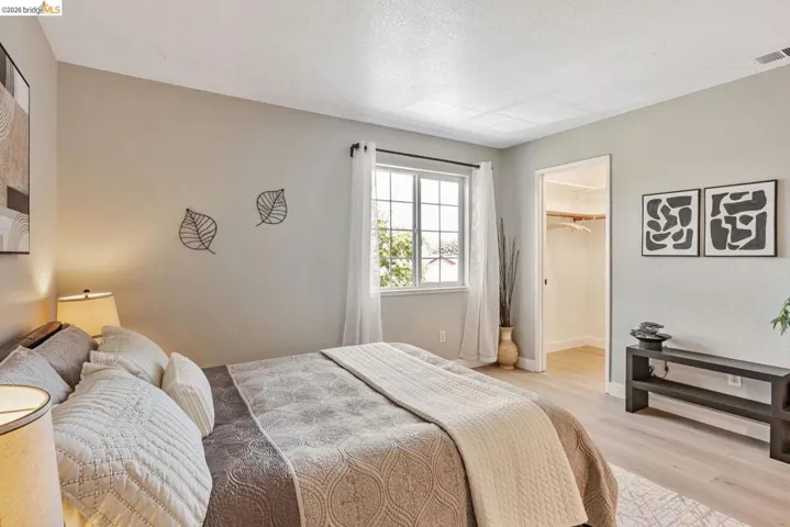 bedroom featuring a spacious closet and light wood-style floors