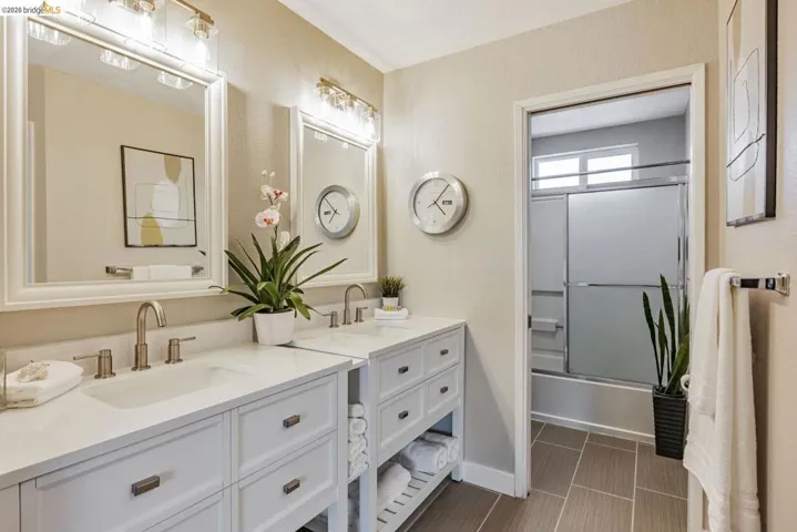 full bathroom with vanity and enclosed tub / shower combo