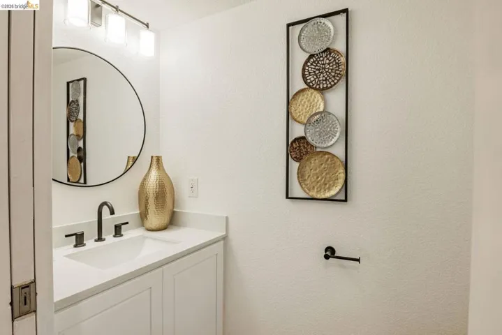 bathroom with vanity and a textured wall