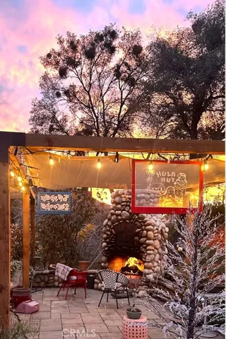 Provided by Seller at Sunset with cozy fire in outdoor fireplace on front patio.