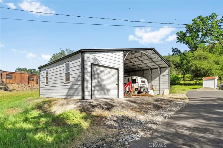  There is also a metal structure providing ample covered storage or parking.