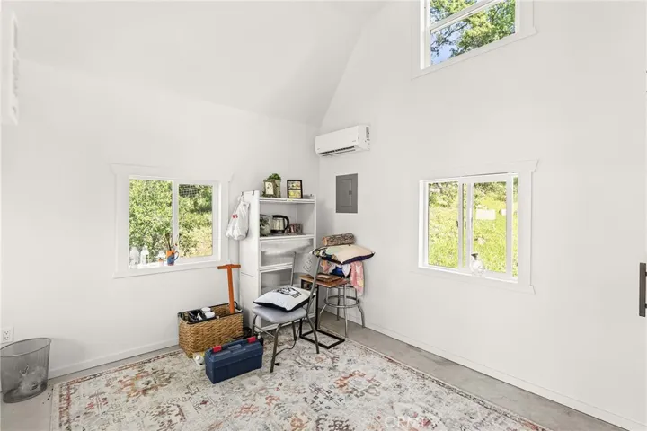 A detached, fully finished studio offers flexible space for an office, art studio, or guest overflow—complete with a loft, closet, and mini-split system.