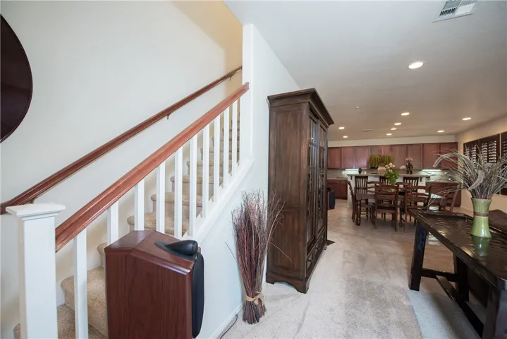 The stairway is on the side of the living room.