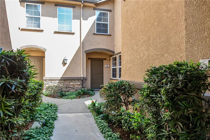 Enter through the beautifully landscaped courtyard to the front door on the right.