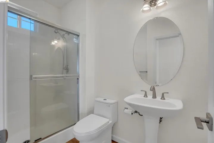 Full bathroom featuring toilet and a shower stall