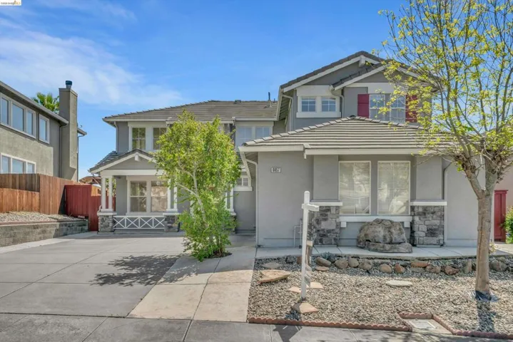 View of front of home with stucco siding and a tile roof