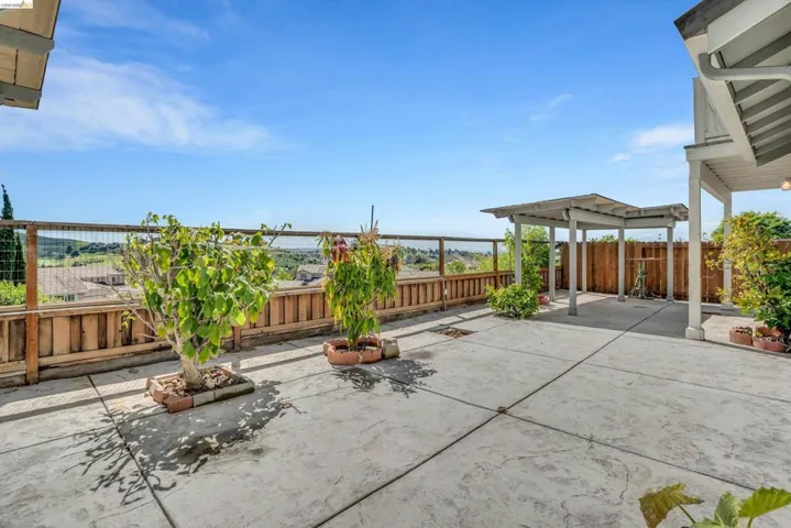 Fenced backyard featuring a patio
