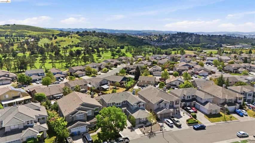 Aerial perspective of suburban area with a mountain backdrop
