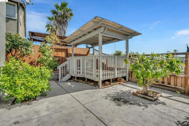 Fenced backyard featuring a deck