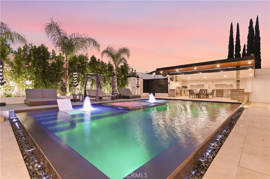 Paradise-like backyard with negative edge pool that lights up the backyard to any color.
