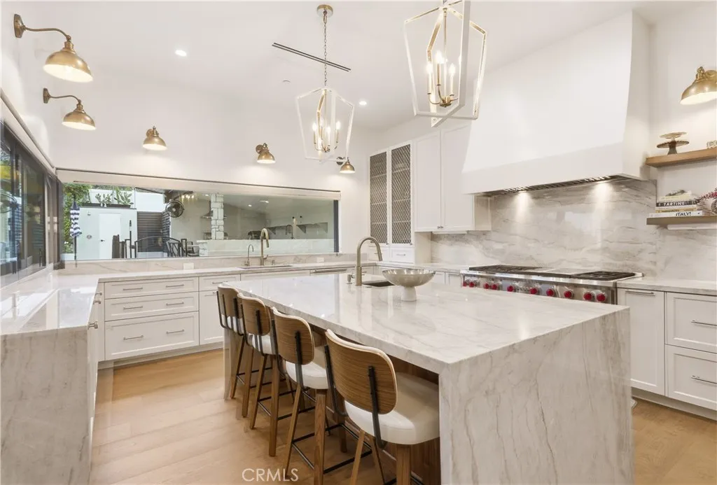 Chef & entertainers kitchen with Taj Mahal Quartzite throughout! 60 inch double oven range by Wolf. Two sinks, two dishwashers, drinking water station, concealed under cabinet lighting & power outlets and much more!