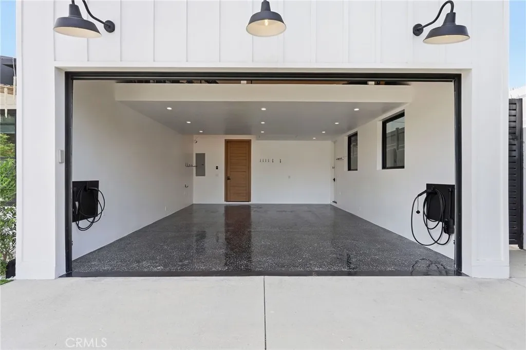 Freshly painted garage w/ two car chargers, attic storage, 2 sky lights and 2 picture windows for natural light along with 21 auto on/off recess lights!