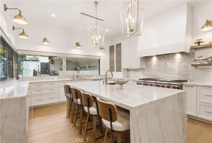 Chef & entertainers kitchen with Taj Mahal Quartzite throughout! 60 inch double oven range by Wolf. Two sinks, two dishwashers, drinking water station, concealed under cabinet lighting & power outlets and much more!