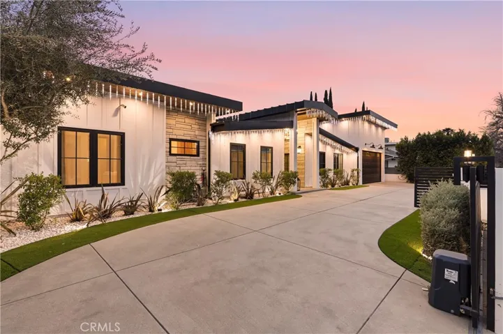 Wrap around driveway with dual motor gates for entry & exit.