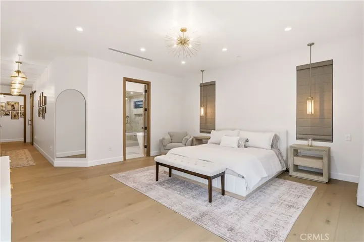 Primary suite with plenty of space for a king sized bed, sitting area, dresser and more. Views of the backyard & pool!