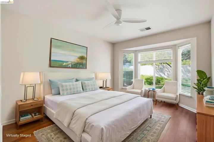 Bedroom with dark wood finished floors and ceiling fan