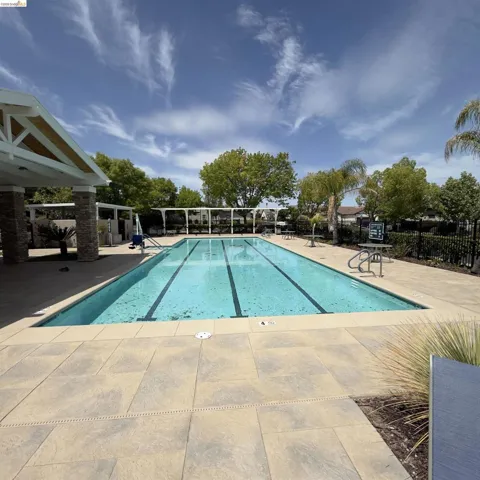 Community pool featuring a patio