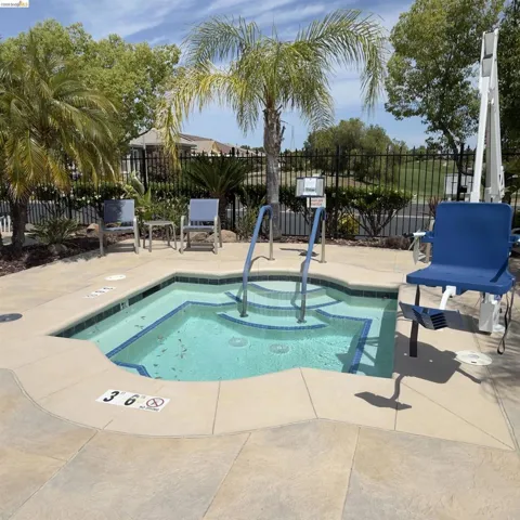 View of pool featuring a pool, patio surround, and a community hot tub