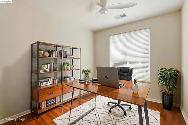 Home office featuring wood finished floors and ceiling fan
