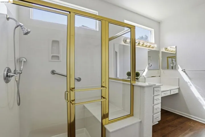 Full bathroom with a stall shower, dark wood-type flooring, and vanity