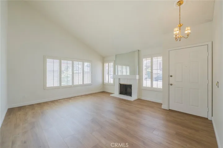 Living room with vaulted ceilings and fireplace.