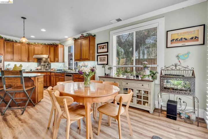 Dining room featuring ornamental molding, light wood-style floors, and recessed lighting