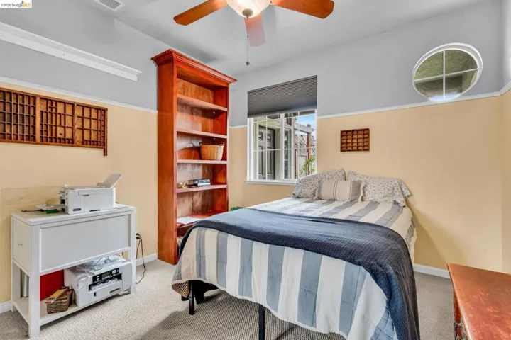 Bedroom featuring light carpet and a ceiling fan